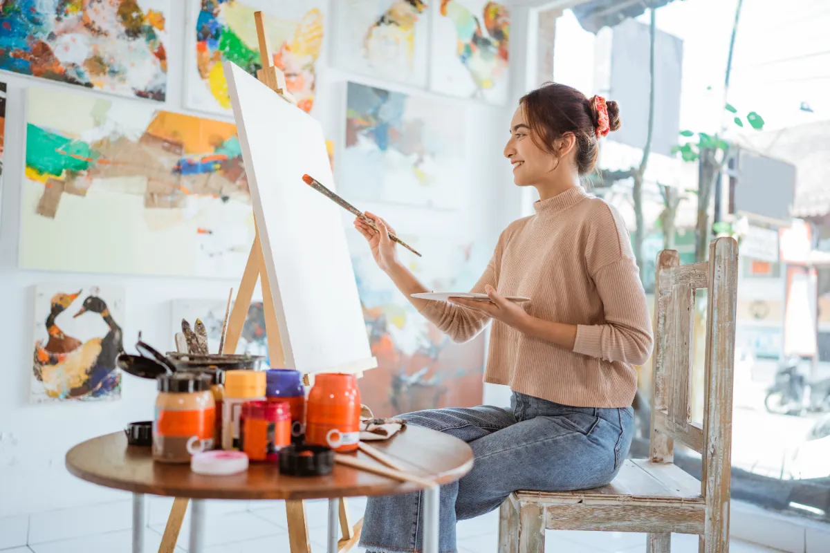 female artist painting in studio