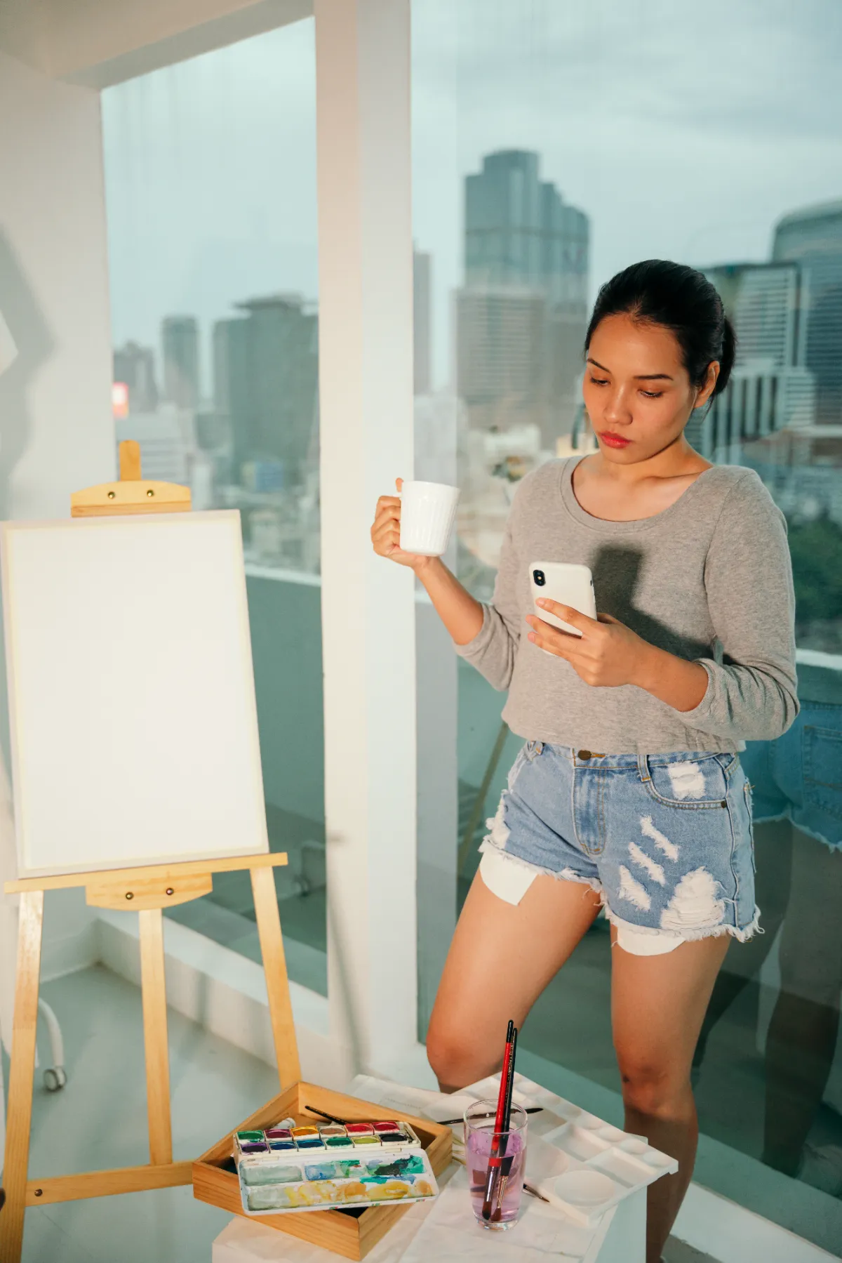 female artist taking a break in art studio