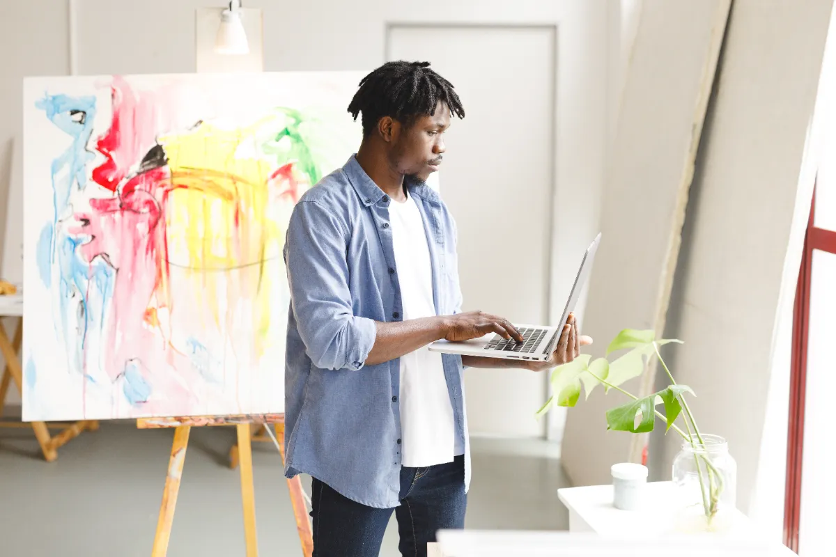 guy on laptop in art studio