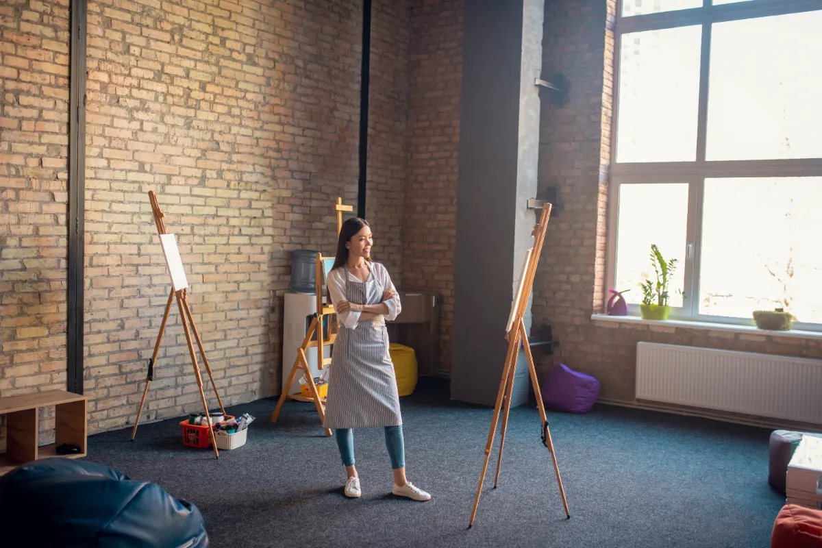 woman in art studio looking at painting