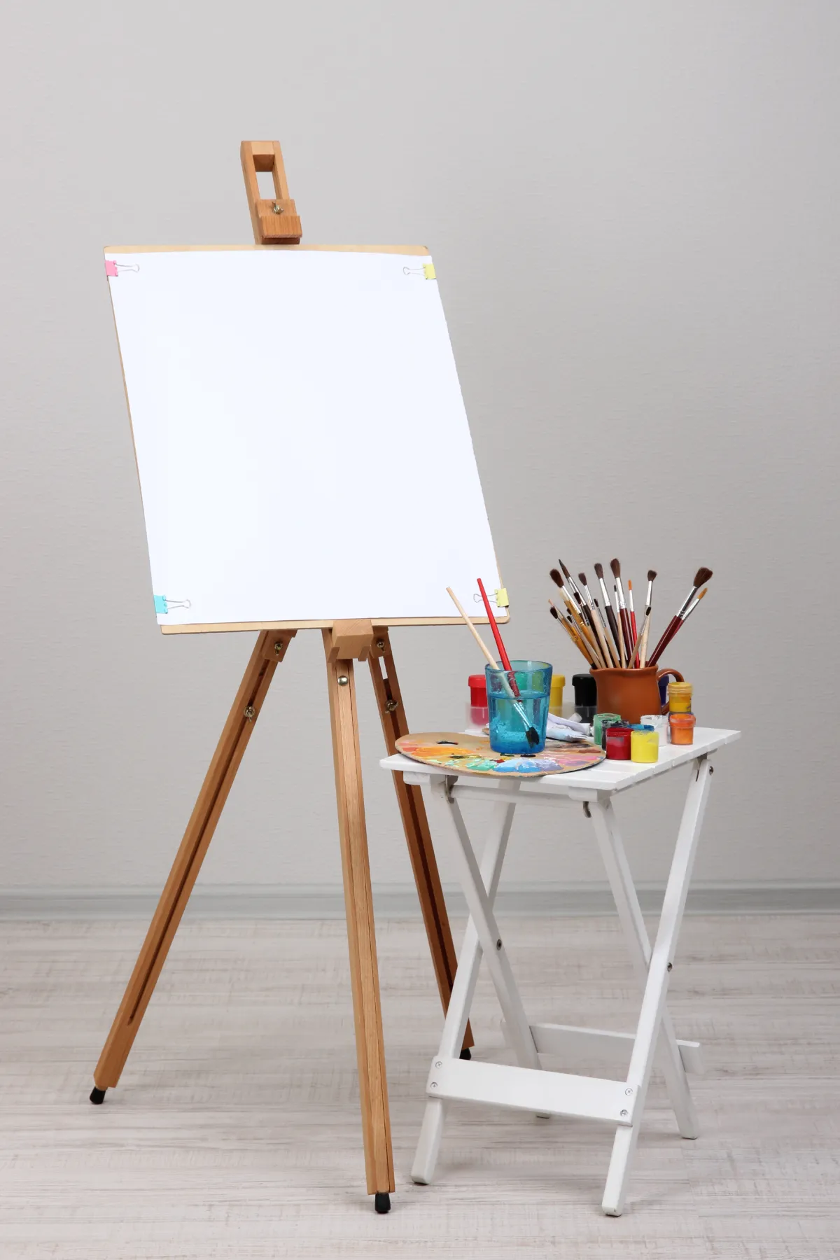 wooden easel with painting supplies