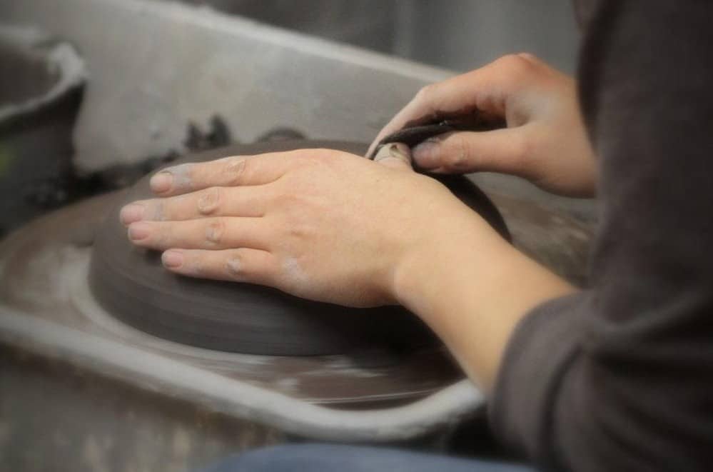 folding clay in a ceramics class