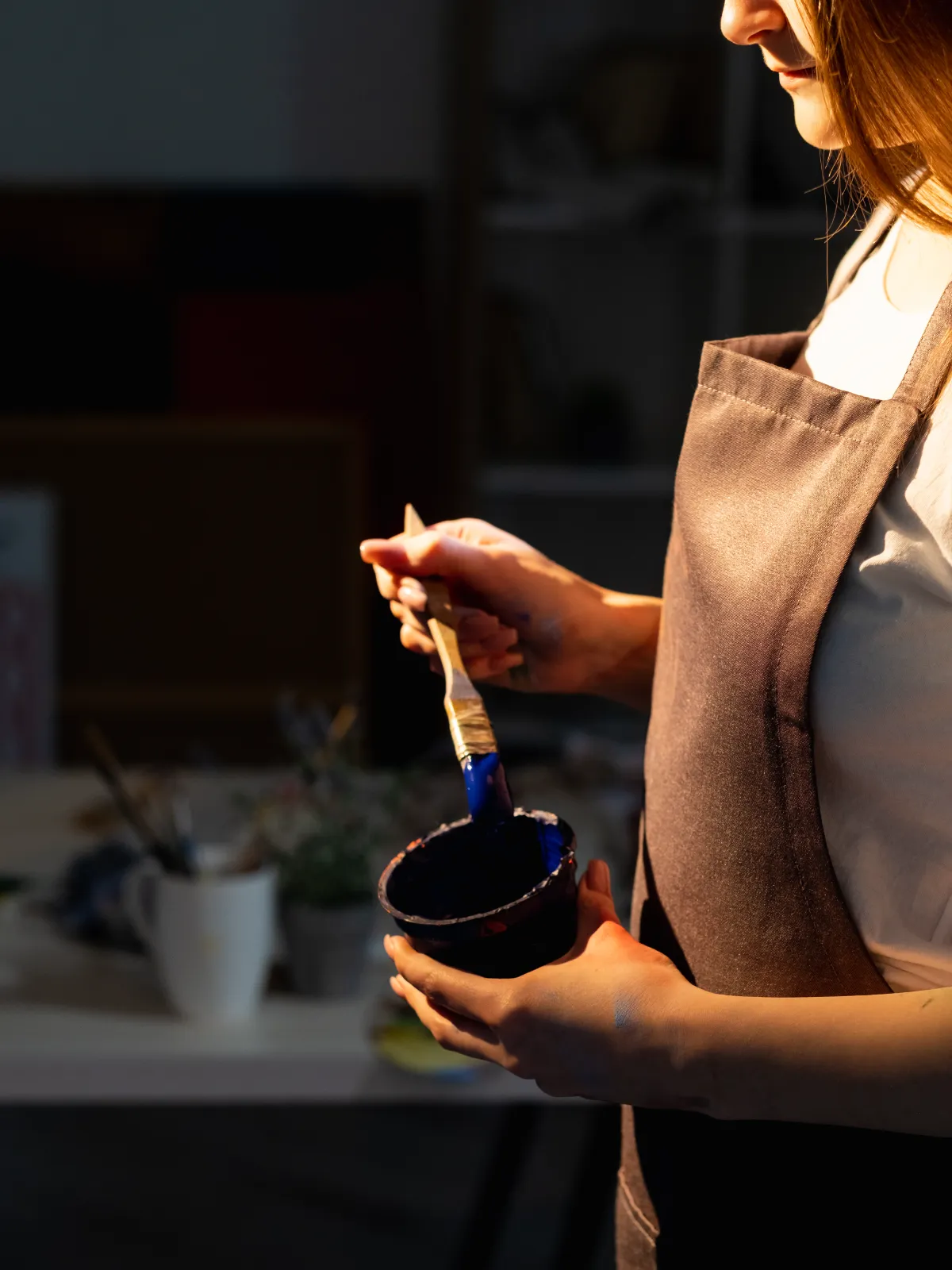 female painter with paintbrush and paint